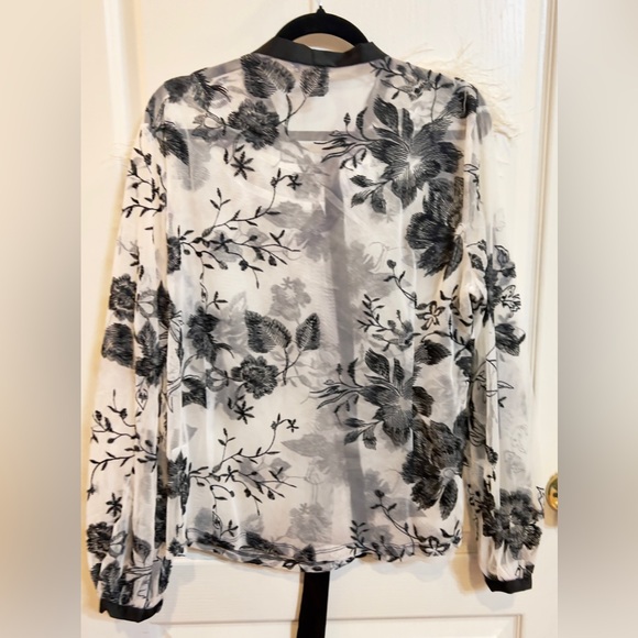 White sheer black floral top with black satin bow ribbon at neck w/ feathers. - Picture 5 of 5